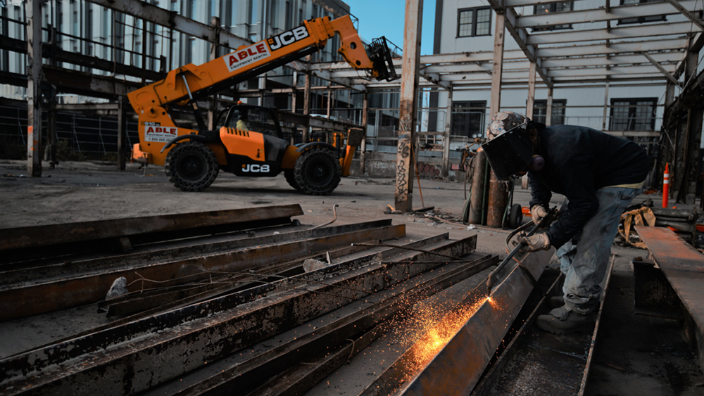 rigging project planning, man welding steel beams