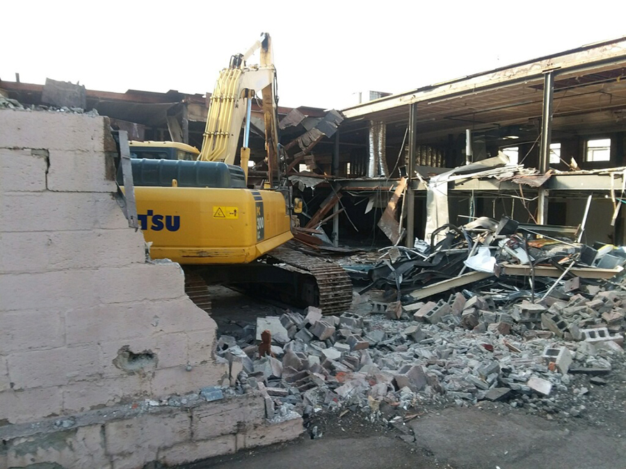 building demolition with machinery